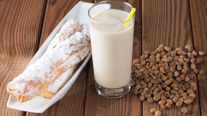 Un vaso de horchata acompañado de fartons y chufa / Foto: Canva