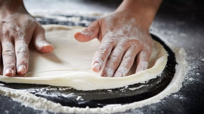 'Pizzaiolo' preparando la masa de una pizza / Foto: Canva