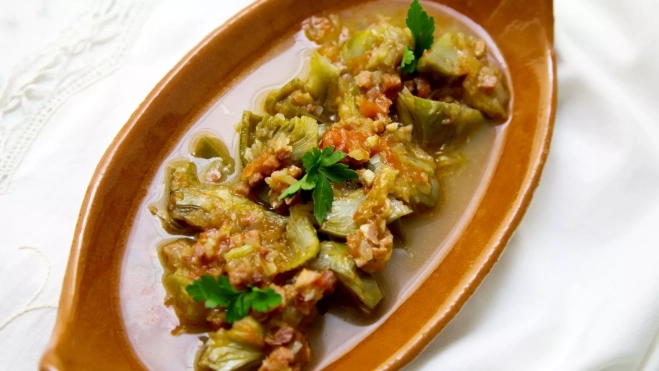 Plato de alcachofas con jamón / Canva